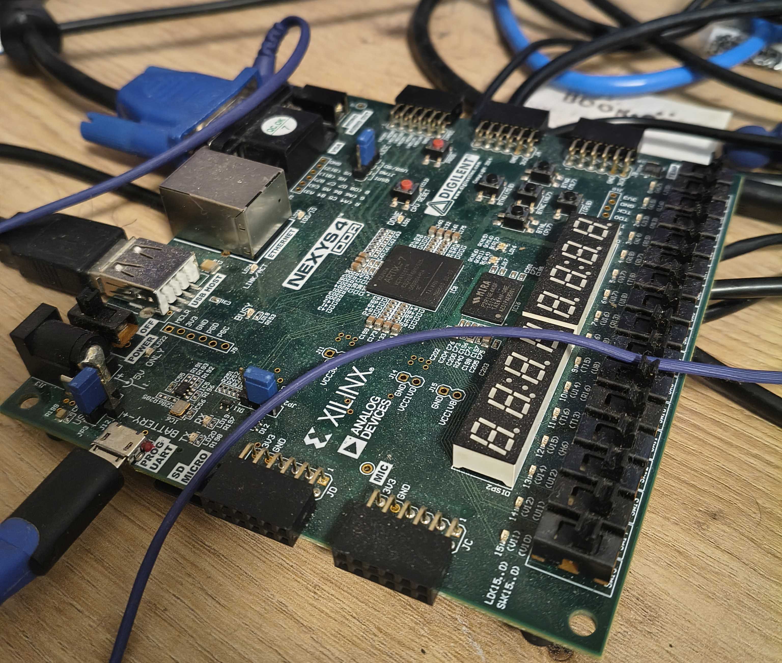 A Nexys 4 DDR Development Board with multiple wires connected.